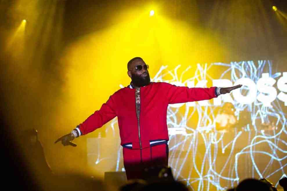 Rick Ross on stage wearing a red jacket