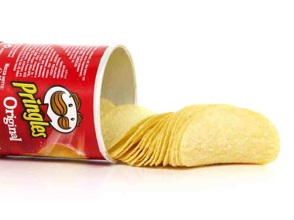 Pringles can on side with chips spilling out