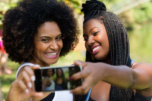 12 quotes women should live by - image of two women of color taking a selfie