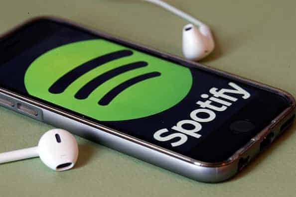 Spotify logo on a phone with headphones