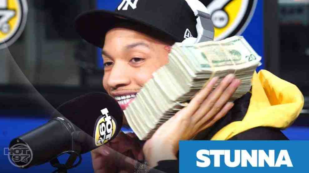 Rapper Stunna4vegas on the microphone with a stack of money to his ear