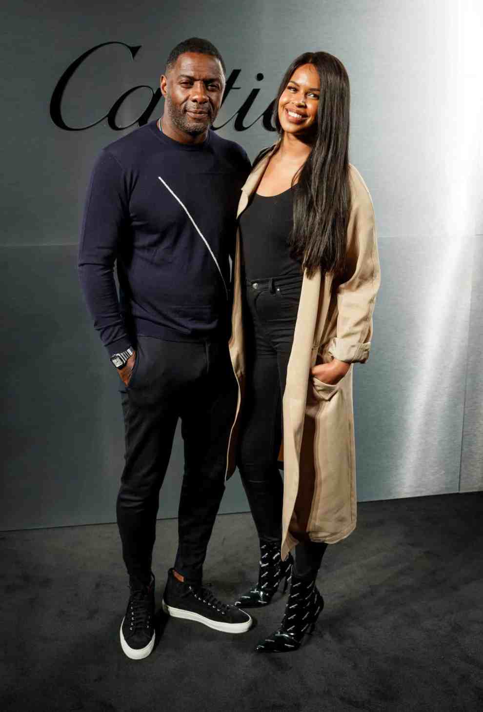 Idris Elba and Sabrina Dhowre wearing Black