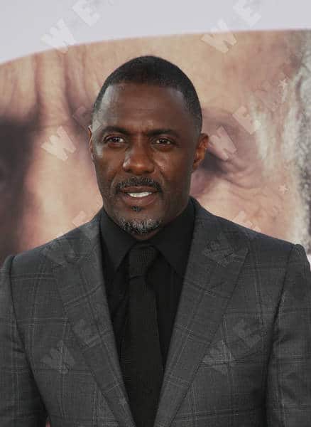 Idris Elba wearing a black suit