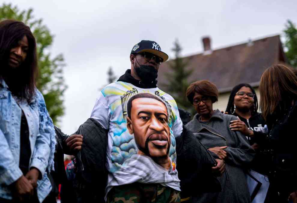 Terrence Floyd (C) removes his jacket to show a shirt bearing the face of his brother, George Floyd, during a vigil on May 25, 2022 in Minneapolis, Minnesota. It has been two years since George Floyd was killed by Minneapolis Police.