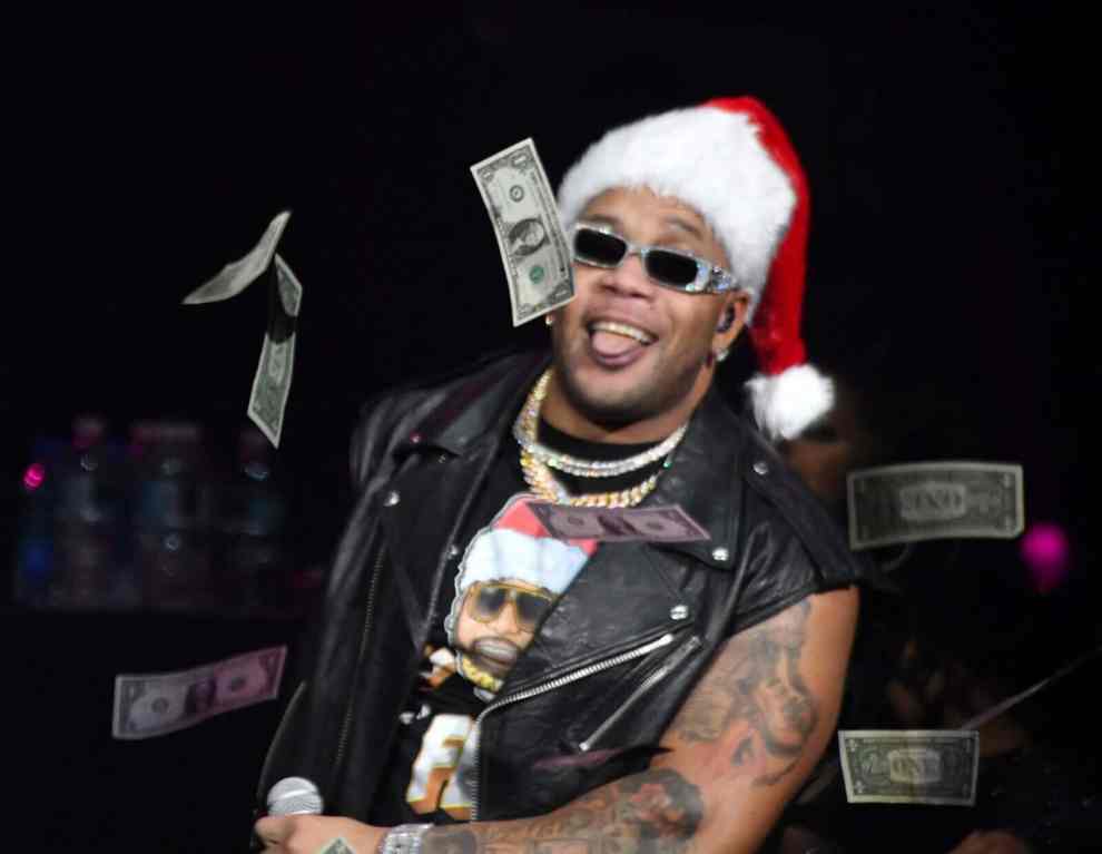 TAMPA, FLORIDA - DECEMBER 16: Flo Rida throws dollar bills as he performs onstage during iHeartRadio 93.3 FLZ’s Jingle Ball 2022 Presented by Capital One at Amalie Arena on December 16, 2022 in Tampa, Florida. Flo Rida Wins $82 Million Lawsuit Against Celsius