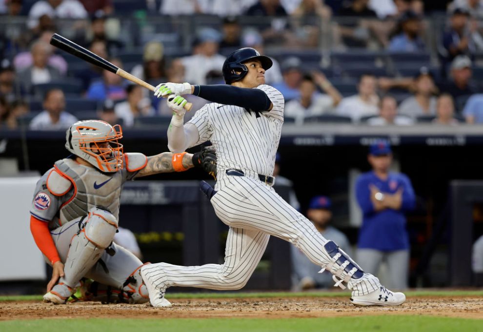 NEW YORK, NEW YORK - JULY 24: Juan Soto #22 of the New York Yankees follows through on his home run in the third inning against the New York Mets at Yankee Stadium on July 24, 2024 in New York City.